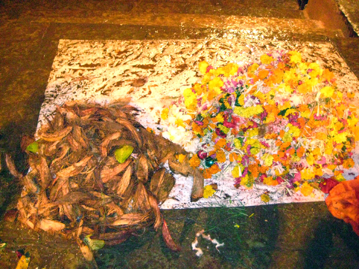 Coconuts and flowers collected at the ghats of the river
